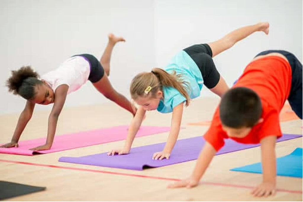 Group of kids performing yoga pose together